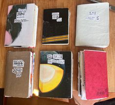 several notebooks are lined up on a table