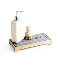 a soap dispenser and toothbrush on a tray