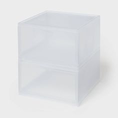 two clear plastic drawers on a white background