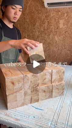 a young man is making wooden blocks out of wood