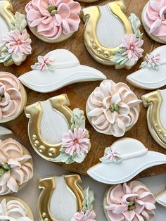 decorated cookies with flowers and horseshoes on a table