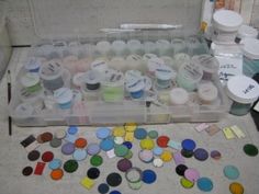 a plastic container filled with lots of different colored paints