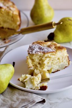 a piece of cake on a plate next to some pears