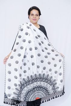 Take in the splendour of this stunning and flawlessly woven Silk Dupatta adorned with mandala art. The black tassels and black and white color scheme contribute to the beauty of this design. Specifications: Brand- Mudita by Lejina Length - 2.5 Meters Color - Black & white Material - Silk. Care Instruction: Dry Clean Only Country of Origin: India Features: 1. The silk dupatta is adorned with digitally printed mandala art. 2. This silk dupatta will have you looking your most gorgeous every season. 3. For a sophisticated touch, this silk dupatta is delicately fashioned with tassels. 4. A fantastic present for women and girls for any occasion. 5. The silk dupatta comes with Customizable colours. Bohemian White Dupatta With Printed Motifs, Traditional Summer Dupatta With Motifs, Traditional Patterned Dupatta For Summer, Traditional Dupatta With Summer Patterns, Traditional Summer Dupatta With Traditional Patterns, White Dupatta With Printed Motifs For Festivals, Bohemian Festival Dupatta With Printed Motifs, Festival Dupatta With Printed Motifs And Traditional Drape, Festival Dupatta With Printed Motifs In Traditional Drape