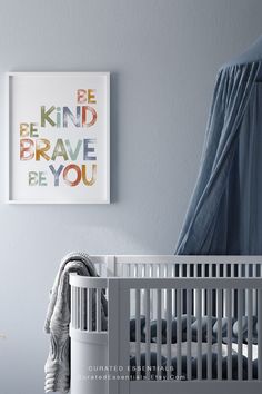 a baby's room with a white crib and blue drapes hanging on the wall