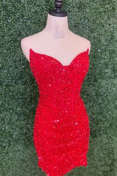 Be a dazzling dynamo in this red-hot sequined piece. The strapless neckline and bodycon silhouette flatter, while a zip-up back and mini length make sure your moves are on point. Oh, and it even has a built-in bra -- you can't beat that! Glamorous Red Corset Dress With Sweetheart Neckline, Glamorous Strapless Mini Dress For Red Carpet, Fitted Red Sequin Dress For Homecoming, Red Bodycon Dress With Fitted Bodice For Party, Red Sequin Dress With Sweetheart Neckline, Fitted Sleeveless Sequin Dress For Red Carpet, Red Strapless Sequin Party Dress, Red Strapless Sequin Dress For Party, Red Sequin Prom Dress With Sweetheart Neckline