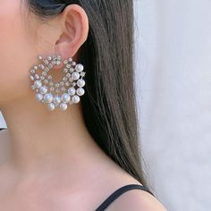 Add an extra dose of elegance to your look with these beautiful pearl earrings. Made of 18K White gold plated, this set is sure to uplift your look. Vaunting a captivating design, is an illustration of fine craftsmanship. It is further enhanced with white cubic zirconia stones that lend it a refining touch. Add a touch of elegance to your outfit with these stunning white pearl round earrings from Barbie Brides. The earrings feature a delicate design with silver and white tones, excellent cut grade cubic zirconia, and imitation pearls that will catch the eyes of anyone. Perfect for any occasion such as wedding, anniversary, graduation, and Valentine's Day, these earrings will add beauty and charm to your look. Crafted with high-quality copper and coated with nickel-free 18K white gold, thes Glamorous Cubic Zirconia Pearl Earrings, Elegant Pearl White Earrings For Party, Silver Pearl Hoop Earrings For Party, Silver Pearl Earrings For Party, Glamorous Pearl Earrings As Gift, Cubic Zirconia Round Pearl Earrings For Party, Pearl White Round Earrings For Party, Glamorous Round Pearl Earrings As Gift, Glamorous Round Pearl Earrings For Gift