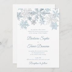 the snowflake wedding card is shown in blue and white, with silver foil on it