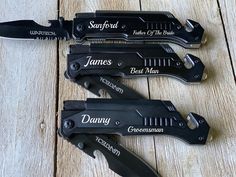 three knives with names on them sitting next to each other in front of a wooden table