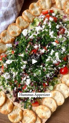 a platter filled with crackers and vegetables