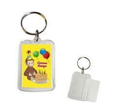 a keychain with an image of a monkey holding a birthday cake