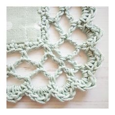 the crochet pattern is shown in white and green