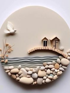 there is a wall decoration made out of rocks and stones with a house on it