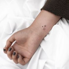 a small star tattoo on the wrist