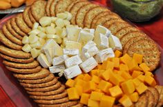 cheese and crackers arranged on a platter