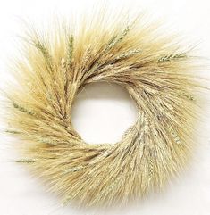 a close up of a wreath made out of grass on a white surface with no people around it