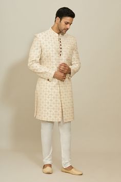 Cream sherwani featuring floral embroidery with zari work all over. Paired with a white churidar. - Aza Fashions Designer Cream Fitted Kurta, Designer White Sherwani With Cutdana, Designer Fitted Cream Sherwani, Designer Off White Traditional Wear With Zari Work, Designer Traditional Wear With Resham Embroidery In Off White, Designer Off White Traditional Wear With Resham Embroidery, Off White Sherwani With Zari Work, Fitted Cream Kurta With Naqshi Detailing, Designer Cream Traditional Wear With Resham Embroidery