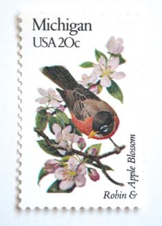 a postage stamp with a bird and flowers on it