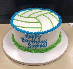 a birthday cake with green and blue frosting