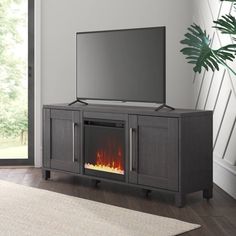 an entertainment center with a fireplace in the middle