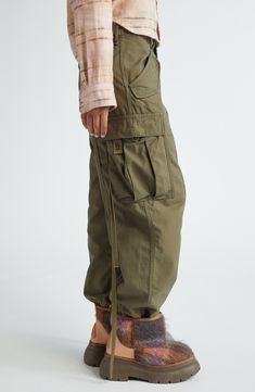 A low-slung waist and a plethora of cargo pockets highlight Chris Leba's rebellious vision in parachute-style pants cut from tactical-inspired cotton twill. Zip fly with button closure Front slant pockets; back flap pockets; cargo flap-patch pockets Drawstring hem 100% cotton Machine wash, line dry Imported Designer Clothing Khaki Parachute Pants With Belt Loops For Outdoor, Khaki Parachute Pants With Belt Loops For Outdoor Activities, Utility Parachute Pants With Belt Loops For Outdoor, Utility Parachute Pants For Outdoor, Outdoor Parachute Pants With Belt Loops And Straight Leg, Utility Parachute Pants For Outdoor Activities, Utility Outdoor Parachute Pants In Cargo Style, Fall Outdoor Cargo Pants With Pockets, Combat Parachute Pants With Straight Leg For Outdoor