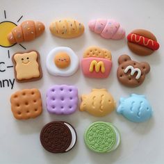 a close up of many different types of cookies and pastries on a white surface