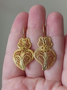 Lovely hand-crafted filigree Viana Heart shaped hook earrings, very traditional in the Minho region of Portugal. In Gold Vermeil, hallmarked, (made in Solid 925 Sterling Silver, with Goldplating). They are brand new with a very pretty Filigree design! Handmade, 3.8cm long They will be send with Polishing Cloth and Certificate of Authenticity, in our Jewellery Box! 📌 Only this pair available!  PS. For Public Health reasons we will not accept returns or exchanges of earrings or piercings. Thank y Sterling Silver Heart Earrings, Silver Heart Earrings, Filigree Earrings, Filigree Design, Sterling Silver Heart, Hook Earrings, Heart Earrings, Silver Heart, Solid 925 Sterling Silver