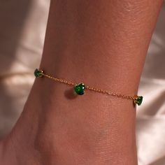 Discover our Emerald Heart Anklet - a uniquely personal "something blue" gift! <3 Featuring a stunning emerald heart charm and a green crystal design, this anklet can be customized with her initial on a back coin. It's the perfect blend of elegance and individuality, making it an unforgettable gift for any special occasion!  # SPECIFICATION Color: 16k gold plated, emerald stone Chain length: 10.5" Please contact us if you need to change chain length. # CARE INSTRUCTION Keep away from the water and soap to maintain good condition! Crystal Anklet, Heart Anklet, Blue Gift, Crystal Design, Ankle Bracelet, Green Crystal, Emerald Stone, Anklet Jewelry, Body Jewellery