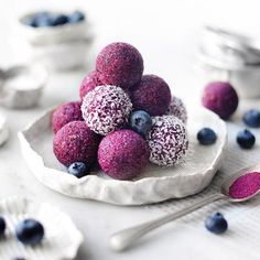 some blueberries and other food on a white plate