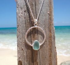 Beautiful Sea Foam Green or Coke Bottle Color Sea Glass Necklace with a sterling silver circle and bezeled sea glass inside. The pendant is hammered for texture to reflect the light. The cultured sea glass is hand tumbled made from recycled glass using colors that remind me of the shades of blue in the ocean. This beach necklace comes on a 16-18 inch or 18-20 inch sterling silver chain and the sea glass pendant measures about 30x24mm. Each sea glass shape will vary slightly as each is handmade. Nickel-free Sea Glass Jewelry For Jewelry Making, Silver Sea Glass Round Pendant Jewelry, Elegant Handmade Sea Glass Necklace, Jewelry Making Rings, Beach Glass Necklace, Adjustable Ocean-inspired Sea Glass Jewelry, Ocean-inspired Sea Glass Necklaces For Beach, Treasure Jewelry, Sea Glass Bracelet