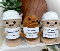 three crocheted coffee mugs with funny faces holding signs that say you can't express how much you mean to me