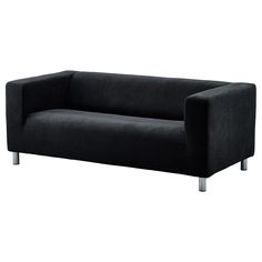 a black couch sitting on top of a white floor