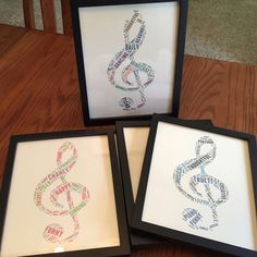 three framed art pieces with words written in different languages on them, sitting on a wooden floor