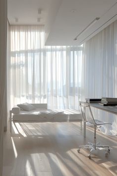 an empty room with white curtains and furniture