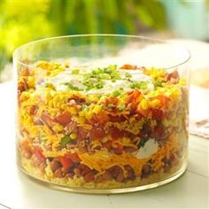 a glass bowl filled with food sitting on top of a table