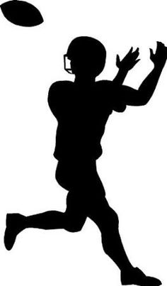 a silhouette of a football player catching a ball