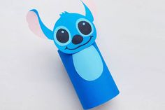 an origami toothbrush holder with a cute blue monster on it's head