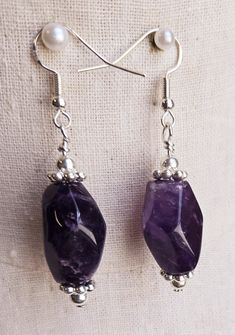 Faceted teardrop amethyst stone beads are strung with silver beads and spacer discs and hung on silver ear wires.   Earrings are strung on 925 silver ear wires and measure over 1 inch long. Purple Amethyst Drop Teardrop Earrings, Purple Amethyst Teardrop Earrings, Purple Gemstone Teardrop Dangle Earrings, Amethyst Gemstone Crystal Drop Earrings, Purple Natural Stone Drop Earrings, Purple Gemstone Bead Dangle Earrings, Purple Gemstone Beads Dangle Earrings, Purple Dangle Earrings With Gemstone Beads, Amethyst Gemstone Teardrop Dangle Earrings