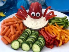 a white plate topped with carrots and cucumbers