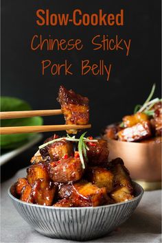 slow cooked chinese sticky pork belly in a bowl with chopsticks