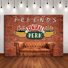 a brick wall with a couch in front of it that says friends central perk