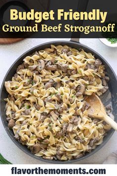 a skillet filled with ground beef and pasta in it, on top of a white table