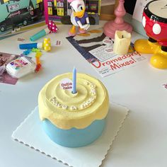 a birthday cake sitting on top of a table next to other toys and decor items