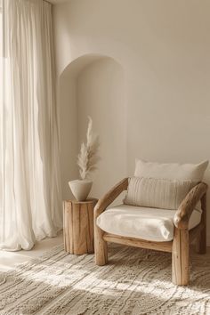 a wooden chair sitting on top of a white rug next to a vase with a plant in it