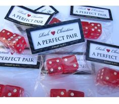 six red dices with white polka dots on them in cellophane bags, sitting next to each other