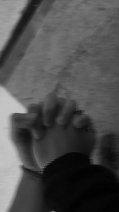 a blurry photo of a person's foot and hand