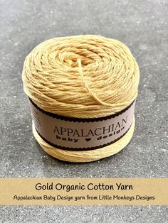 a spool of yellow twine sitting on top of a gray surface with the words appalachian printed on it