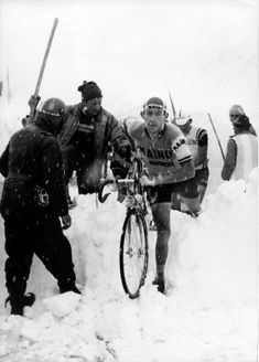 a group of men standing next to each other in the snow