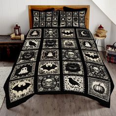 a black and white quilted bed with halloween decorations