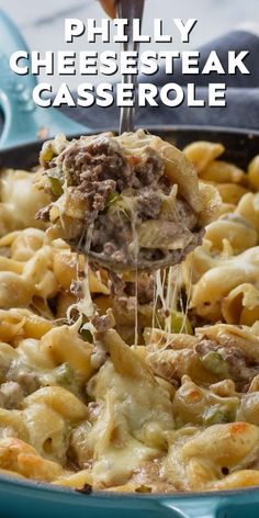 a blue casserole dish with meat and cheese being lifted by a spatula